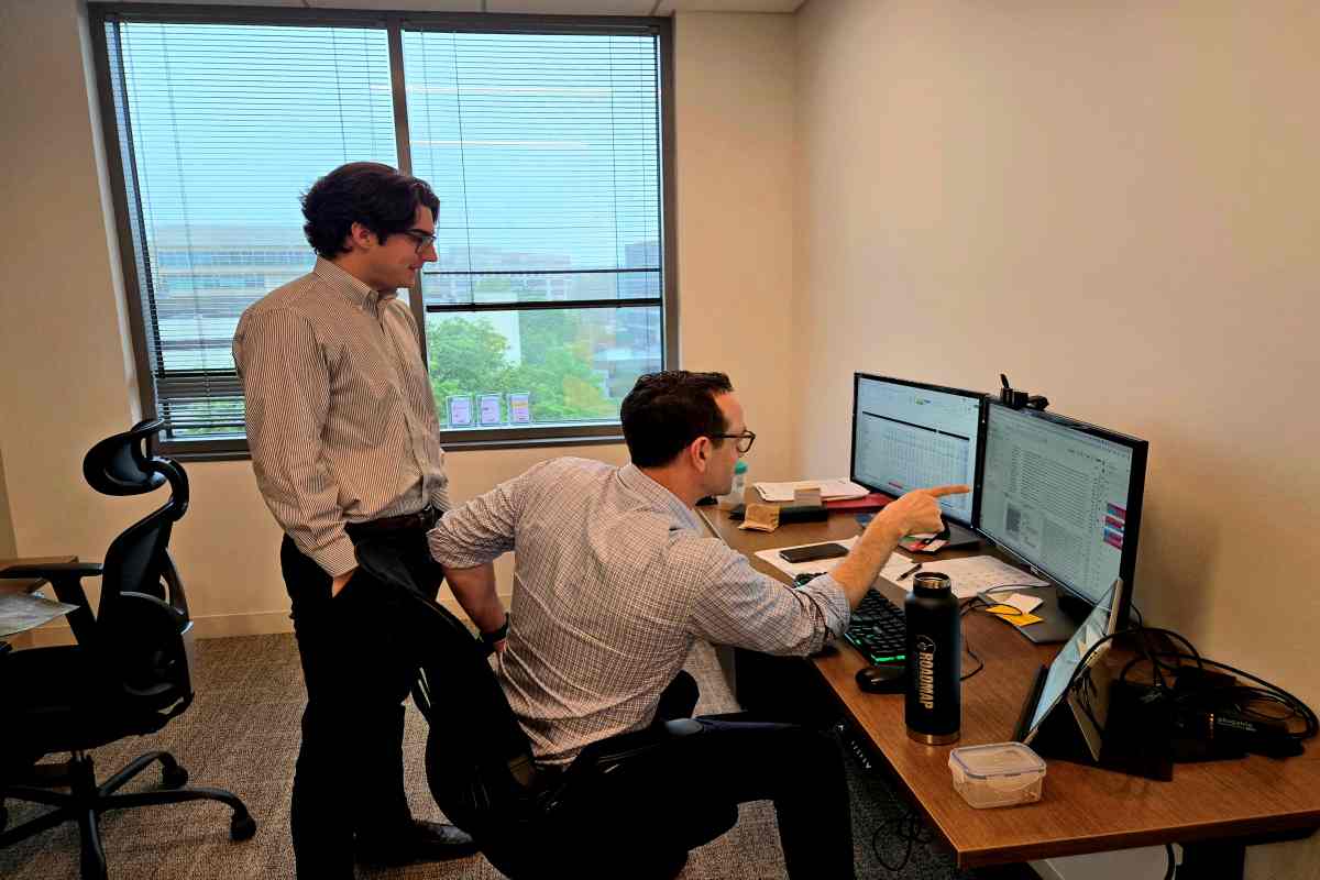 M&A Consultants Watching Data on Computer